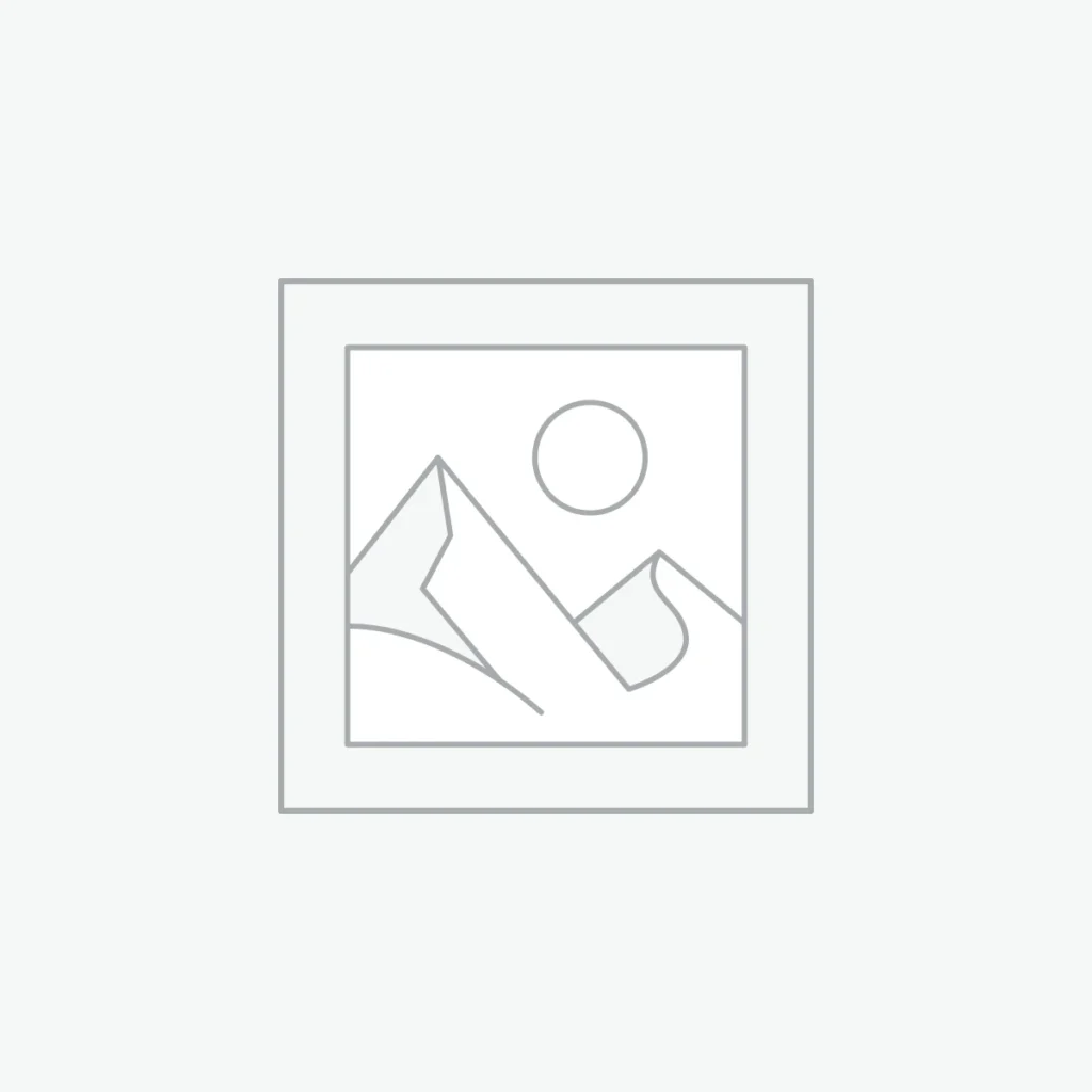 A modern, minimalist workspace with a laptop and a coffee cup on a wooden desk.